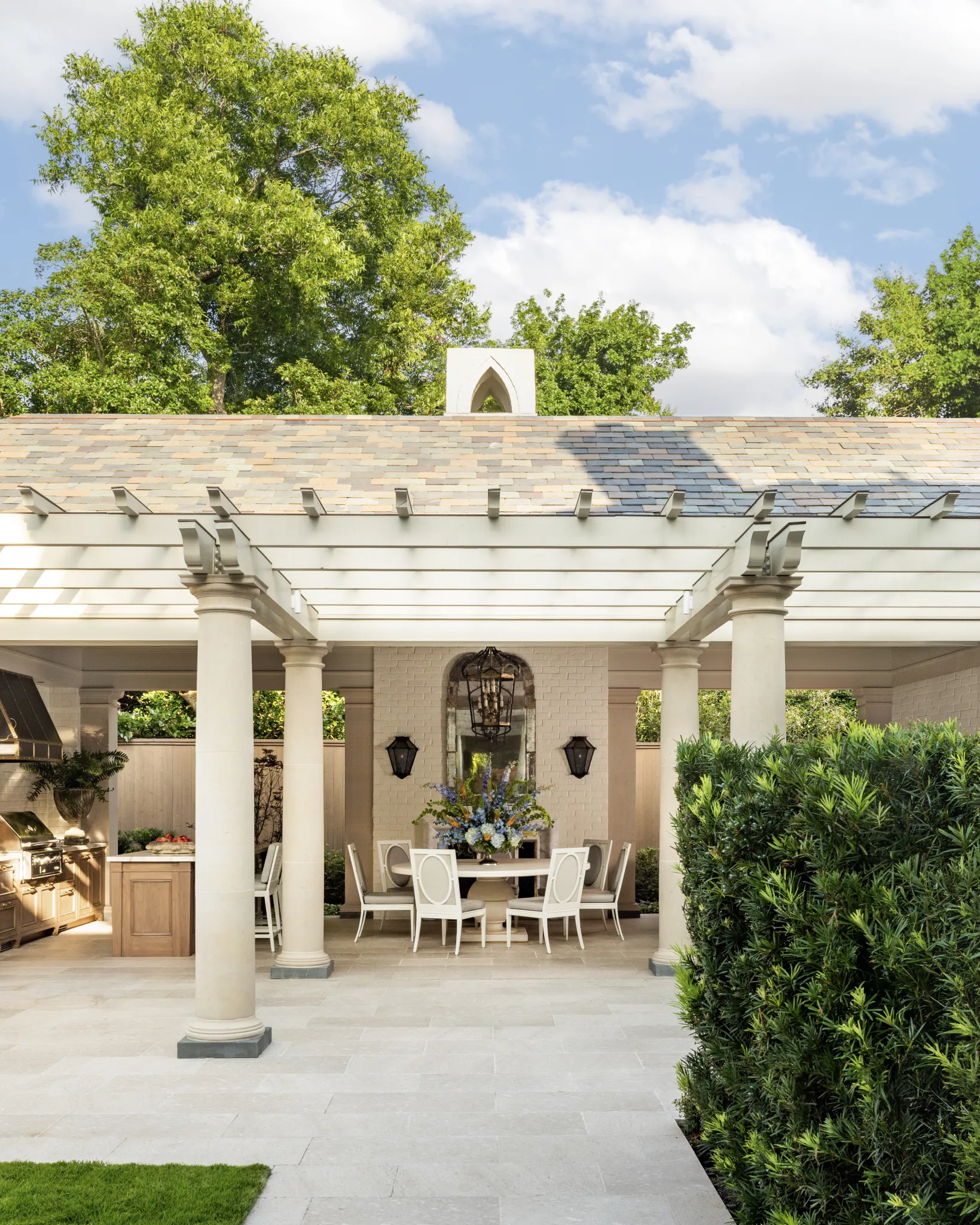 Limestone columns framing the pergola and covered outdoor dining room