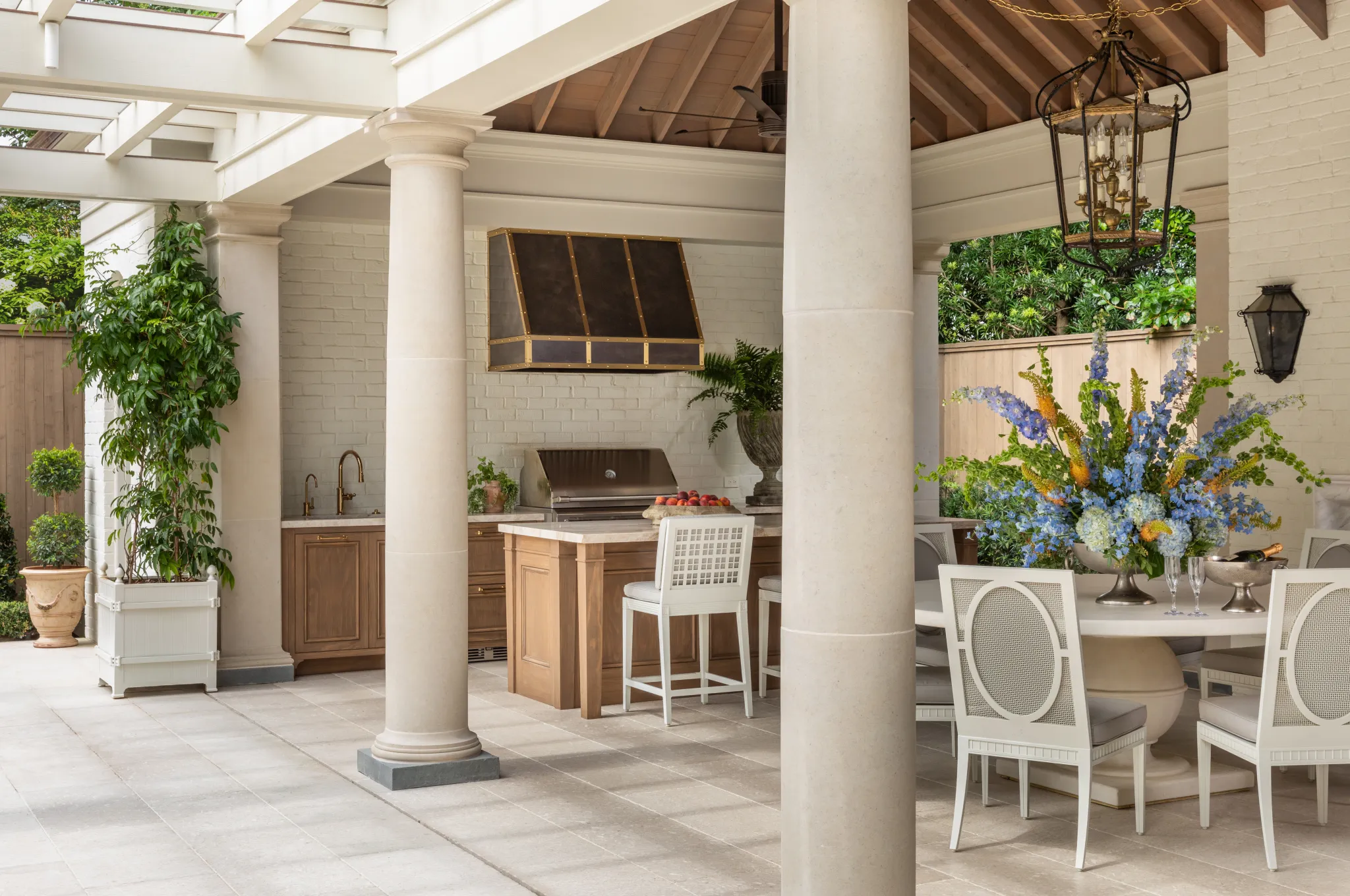 Columned loggia opening onto the outdoor kitchen and dining area